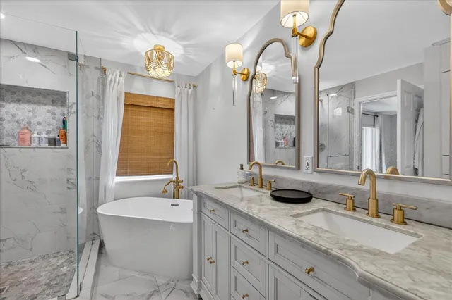 a bathroom with a granite countertop double vanity sink and a mirror