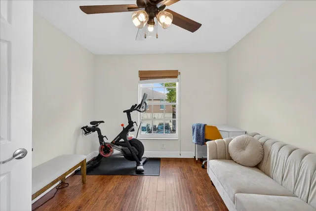 a living room with furniture and a wooden floor