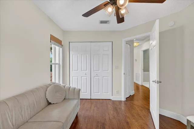 a living room with furniture and wooden floor