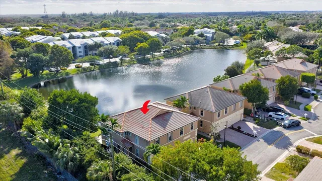 an aerial view of house with yard swimming pool and lake view