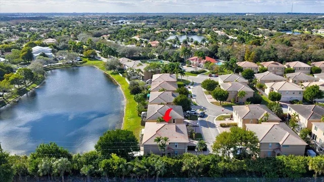 an aerial view of residential houses with outdoor space and swimming pool