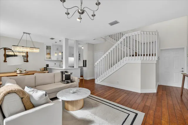 a living room with furniture and a wooden floor