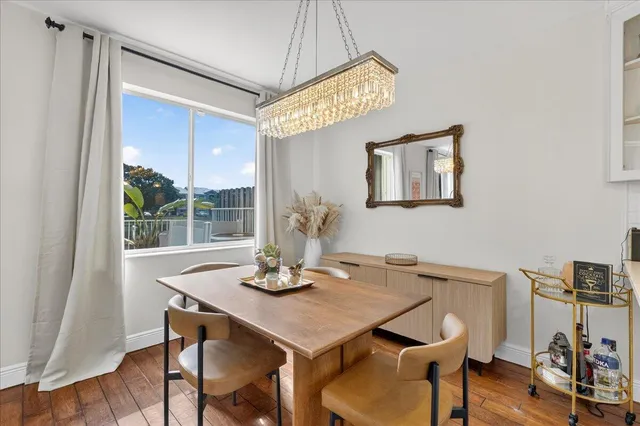a view of a dining room with furniture window and wooden floor