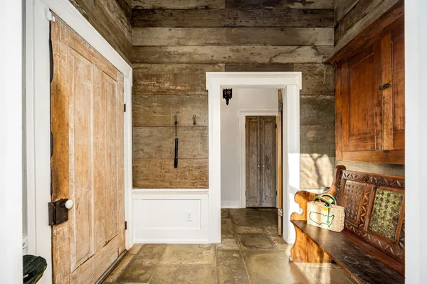 a living room with furniture a window and potted plants