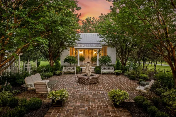 a picture of a house with a fountain