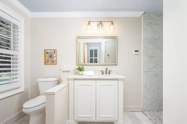 a bathroom with a sink a mirror and a shower