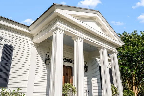 a black and white bench sitting in front of a building