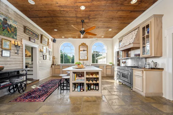 a large kitchen with lots of counter top space and stainless steel appliances