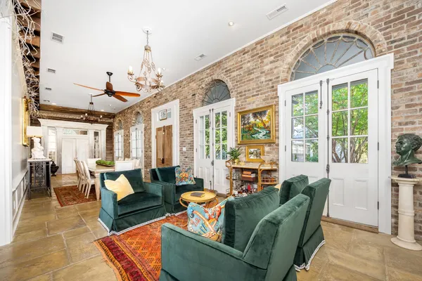 a living room with furniture and large windows