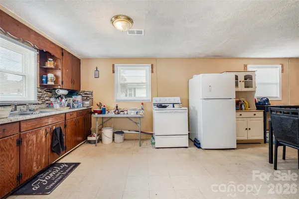 a kitchen with refrigerator and stove