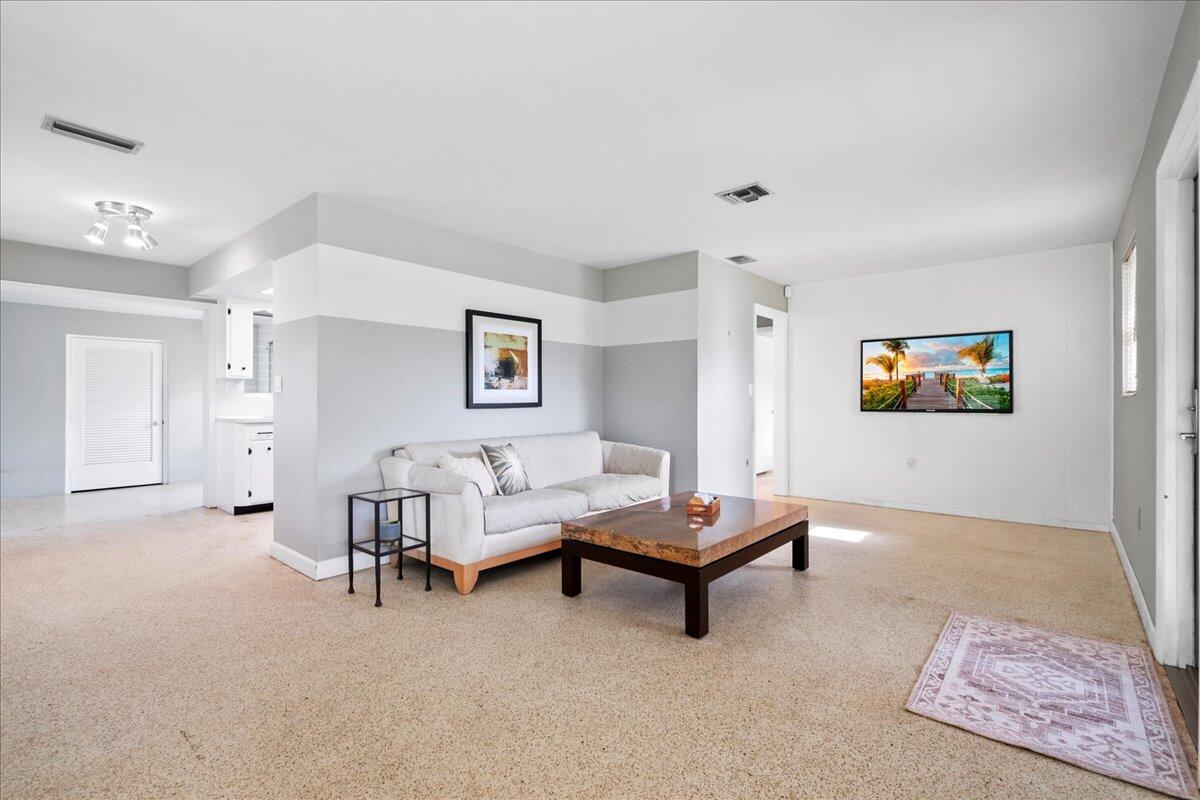 606 Pinegrove Avenue Jupiter, FL 33458 - Photo 2 of 11 a living room with furniture and a rug