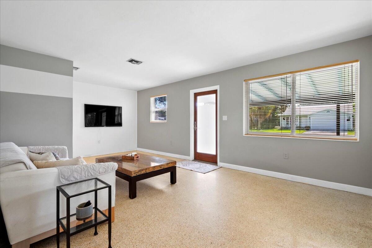 606 Pinegrove Avenue Jupiter, FL 33458 - Photo 3 of 11 a living room with furniture and a window