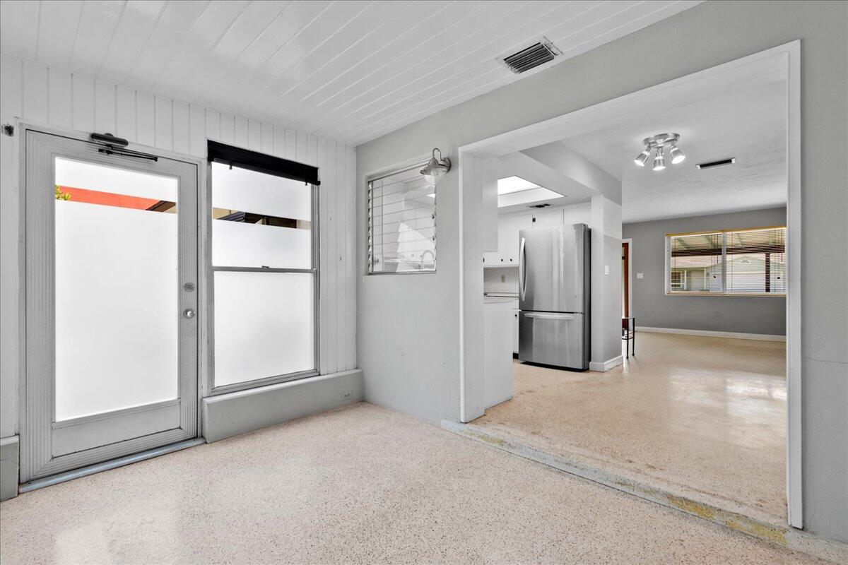606 Pinegrove Avenue Jupiter, FL 33458 - Photo 6 of 11 a view of a hallway with wooden shelves