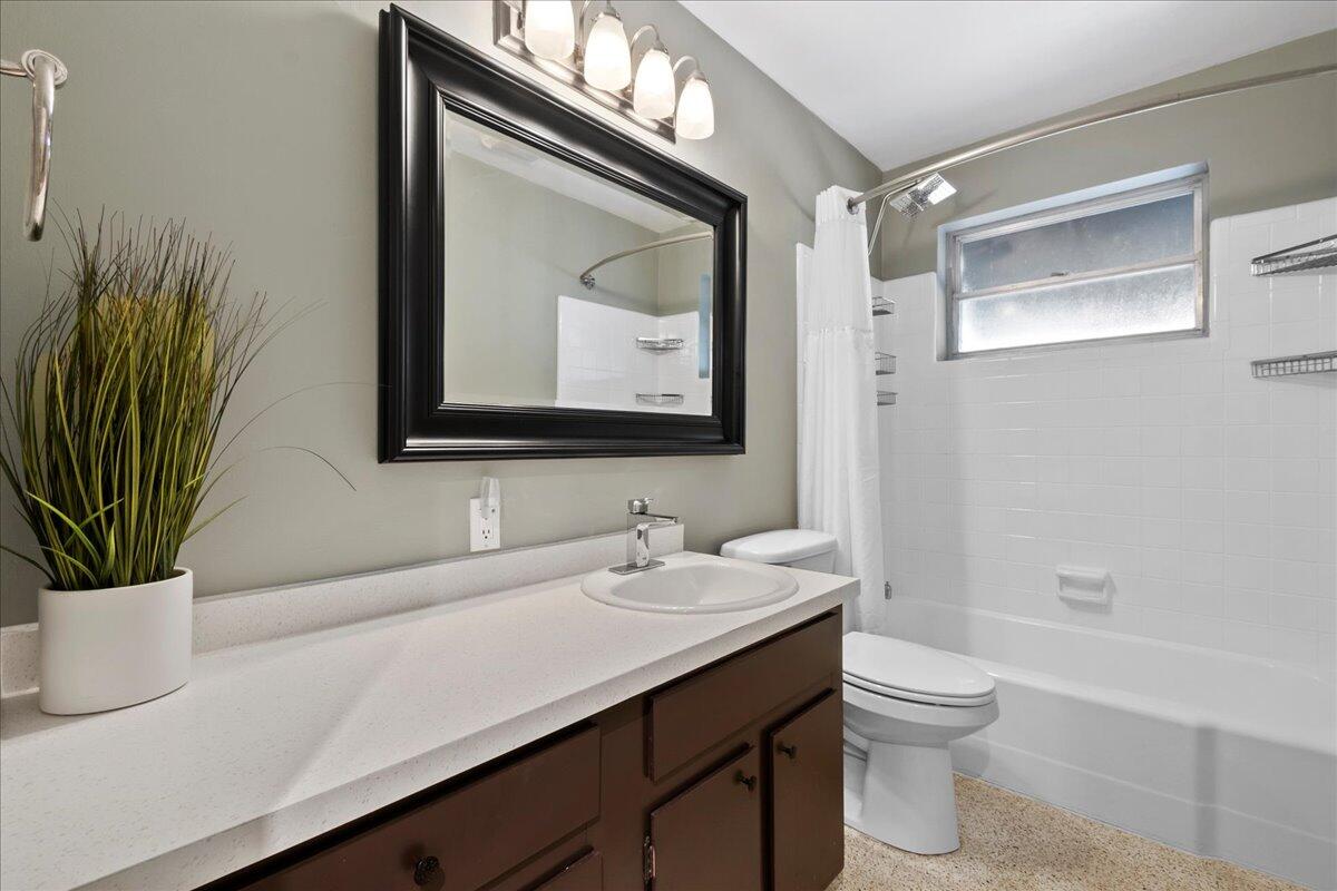 606 Pinegrove Avenue Jupiter, FL 33458 - Photo 8 of 11 a bathroom with a toilet sink and mirror