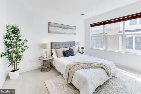 a bed sitting in a bedroom next to a window