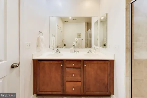 a bathroom with a sink vanity and a mirror