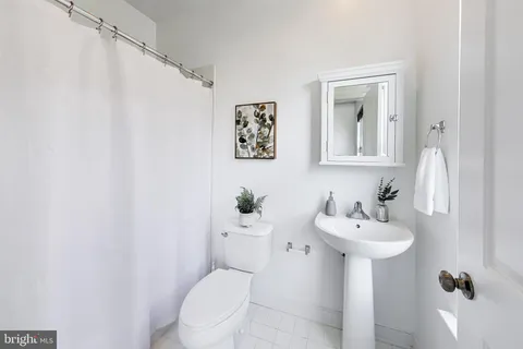 a bathroom with a sink mirror toilet and vanity