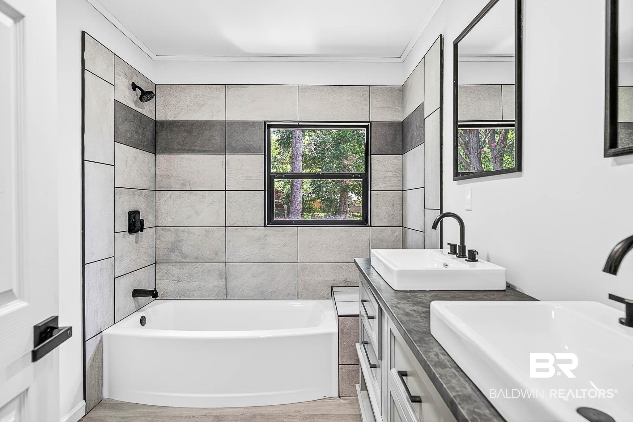 101 Terry Avenue Brewton, AL 36426 - Photo 45 of 48 Bathroom featuring double vanity, bathtub / shower combination, and wood finished floors
