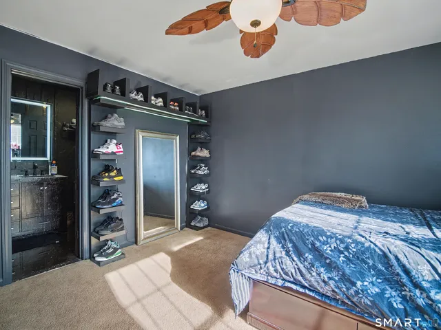 a bedroom with a bed and a mirror