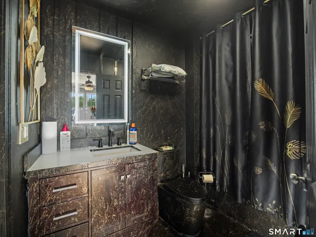 a bathroom with a sink a mirror and shower