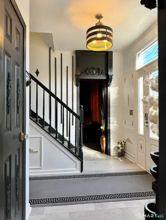 a view of entryway and hall with wooden floor