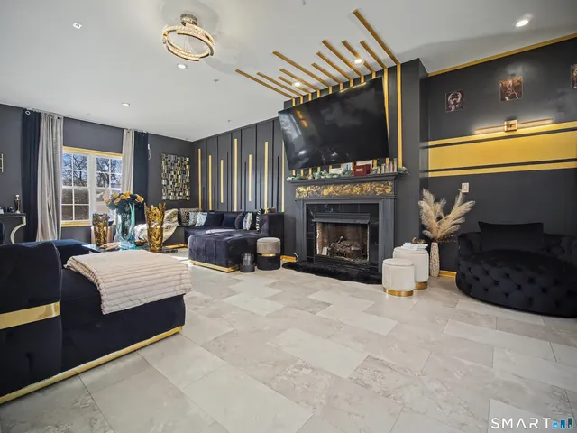 a living room with furniture a fireplace and a flat screen tv