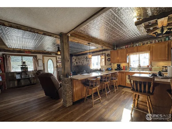 a kitchen with granite countertop a sink and a stove top oven
