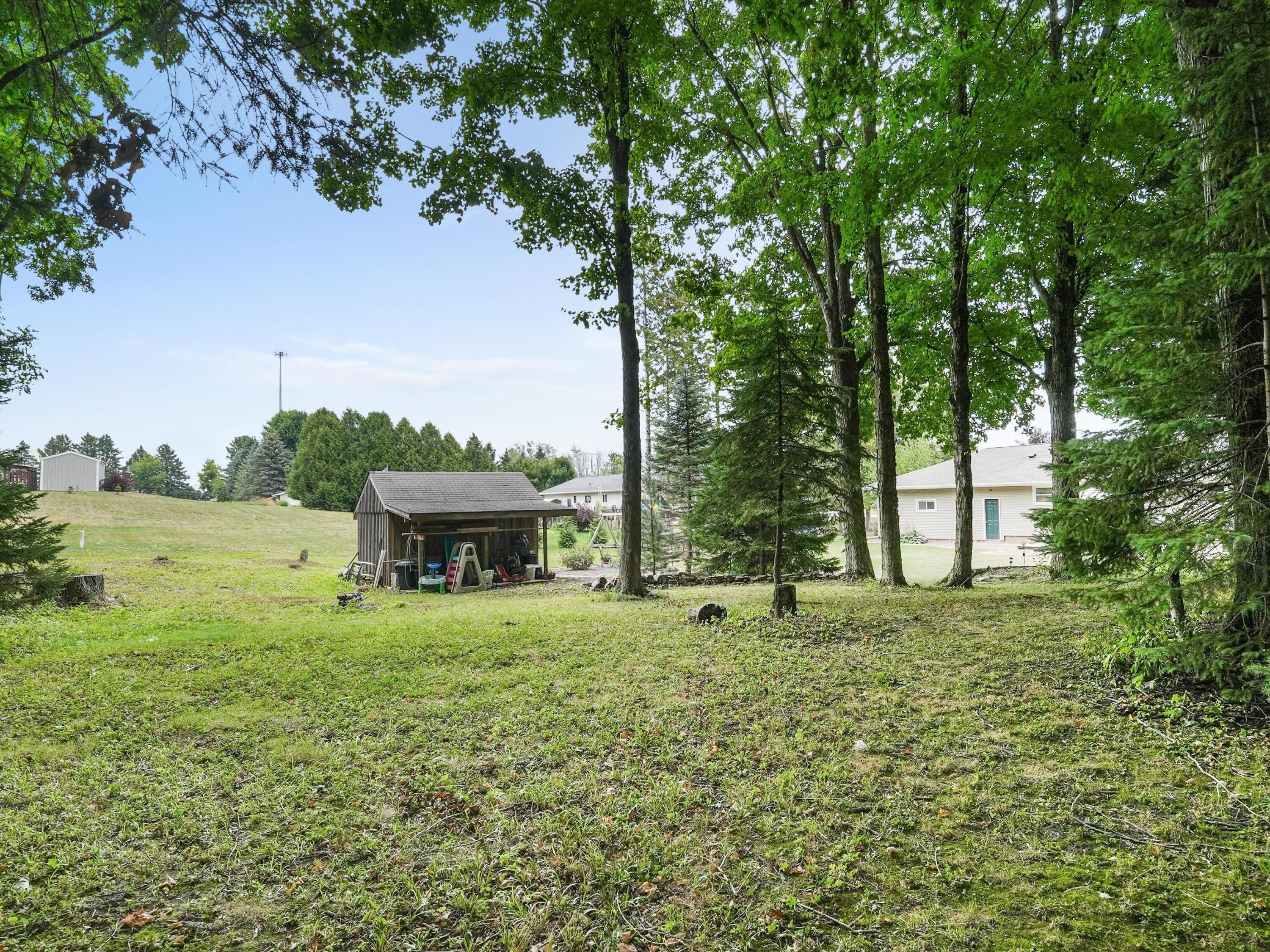 217 East Samz Road Mishicot, WI 54228 - Photo 16 of 43 16-Looking from wooded area to backyard