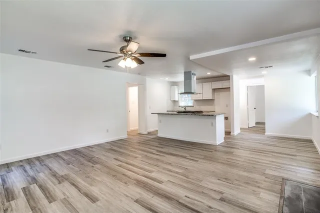 a kitchen with granite countertop a stove and a wooden floors
