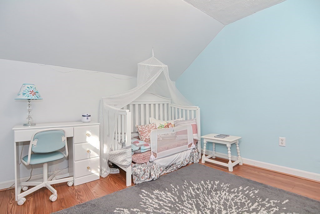 9 Bridge Street Grafton, MA 01536 - Photo 20 of 34 a living room with furniture a rug and white walls