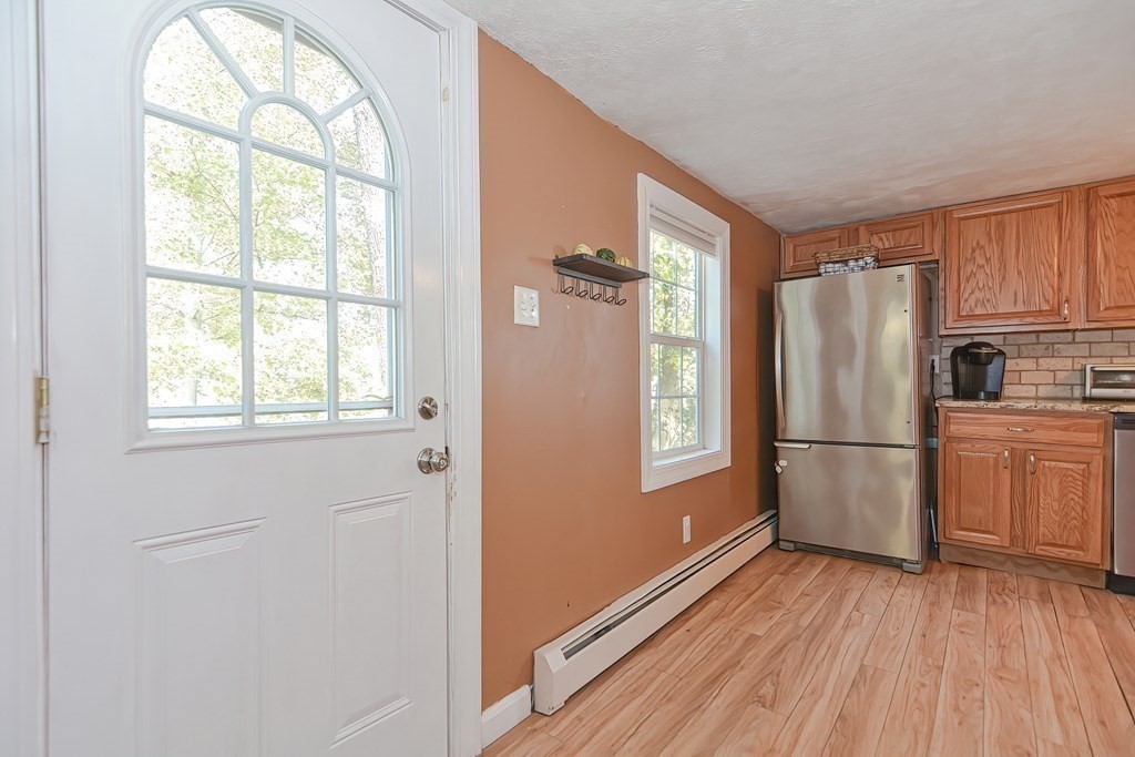 9 Bridge Street Grafton, MA 01536 - Photo 4 of 34 a kitchen with a refrigerator wooden floor and window