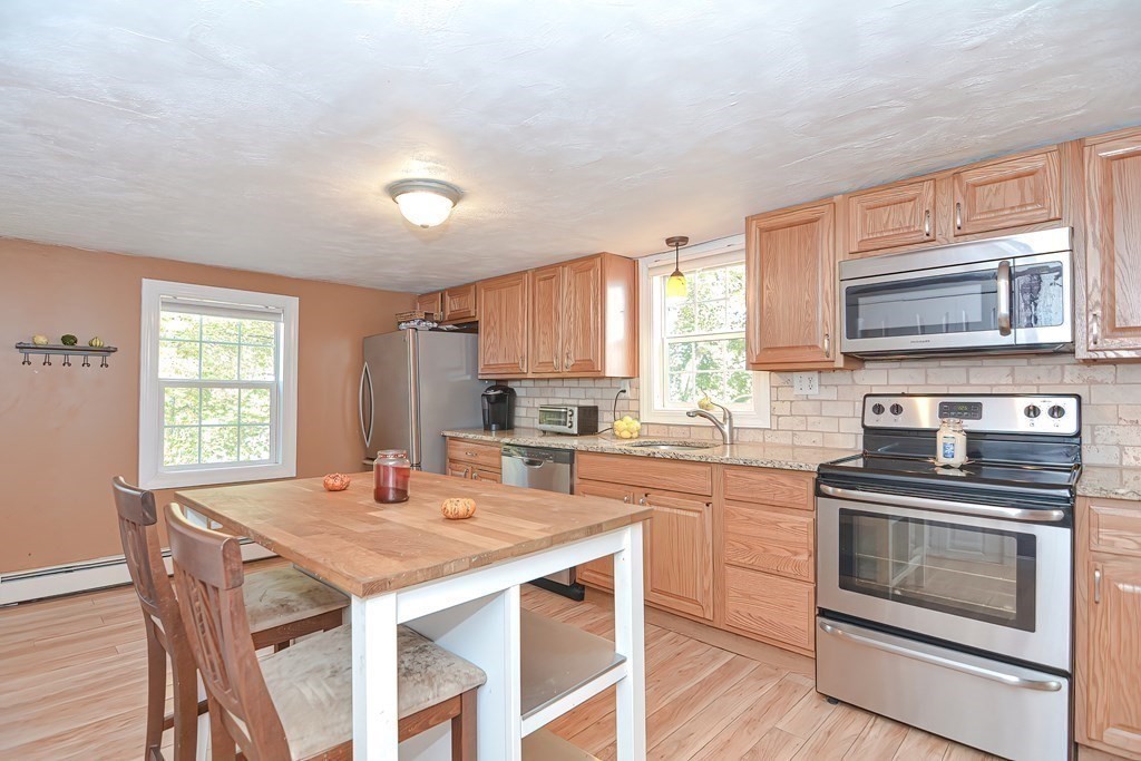 9 Bridge Street Grafton, MA 01536 - Photo 9 of 34 a kitchen with a stove a sink and a microwave