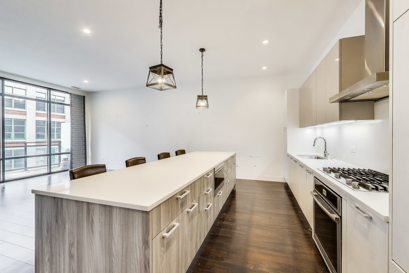 36 North Carpenter Street, Unit 4S Chicago, IL 60607 - Photo 11 of 32 a kitchen with a stove a sink and wooden floor