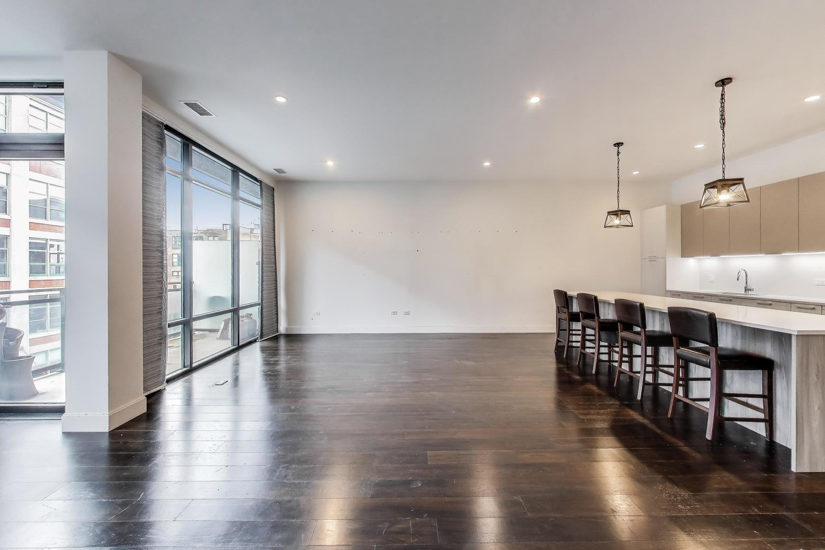 36 North Carpenter Street, Unit 4S Chicago, IL 60607 - Photo 12 of 32 a view of kitchen with furniture and wooden floor