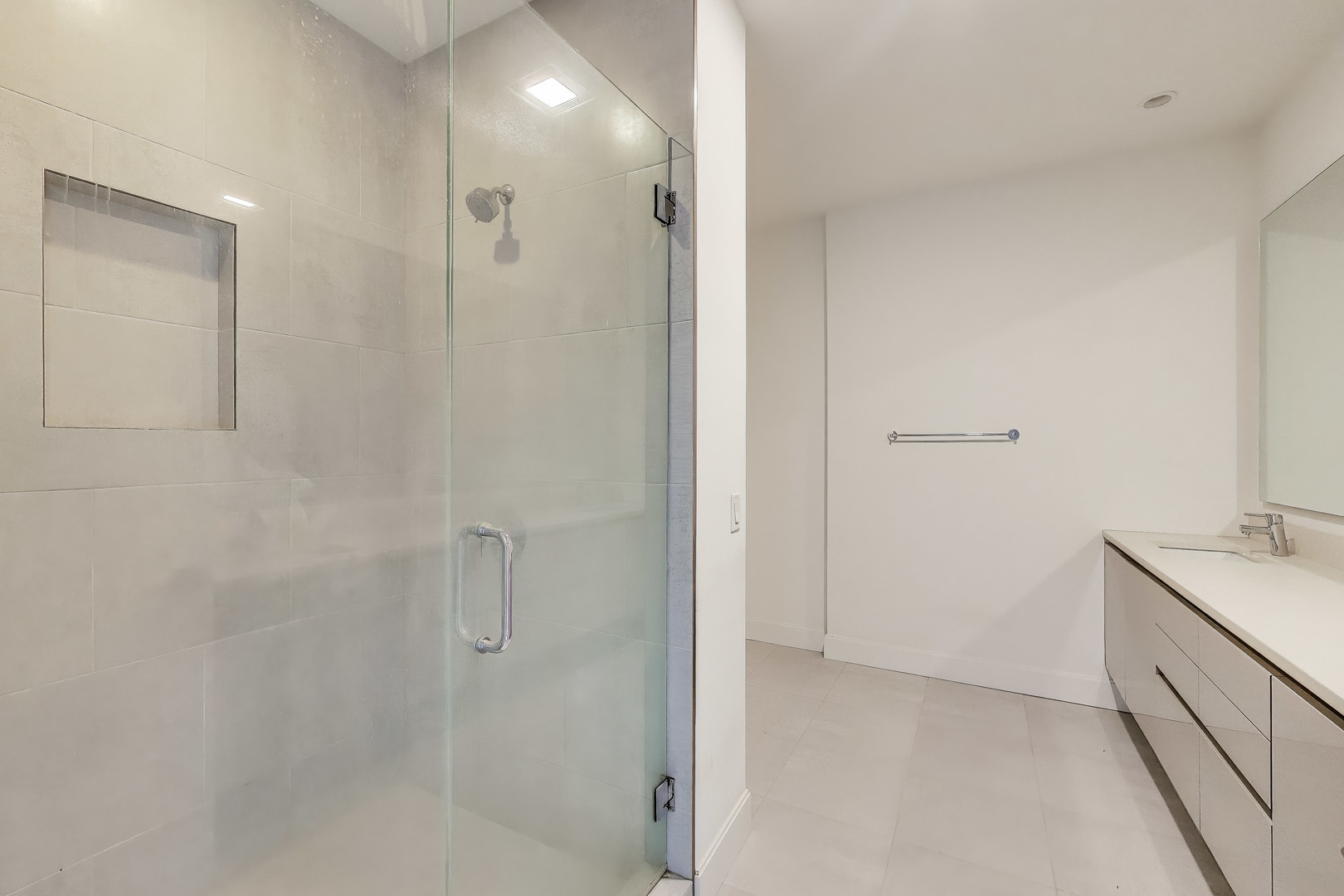 36 North Carpenter Street, Unit 4S Chicago, IL 60607 - Photo 22 of 32 a bathroom with a granite countertop sink a shower and mirror