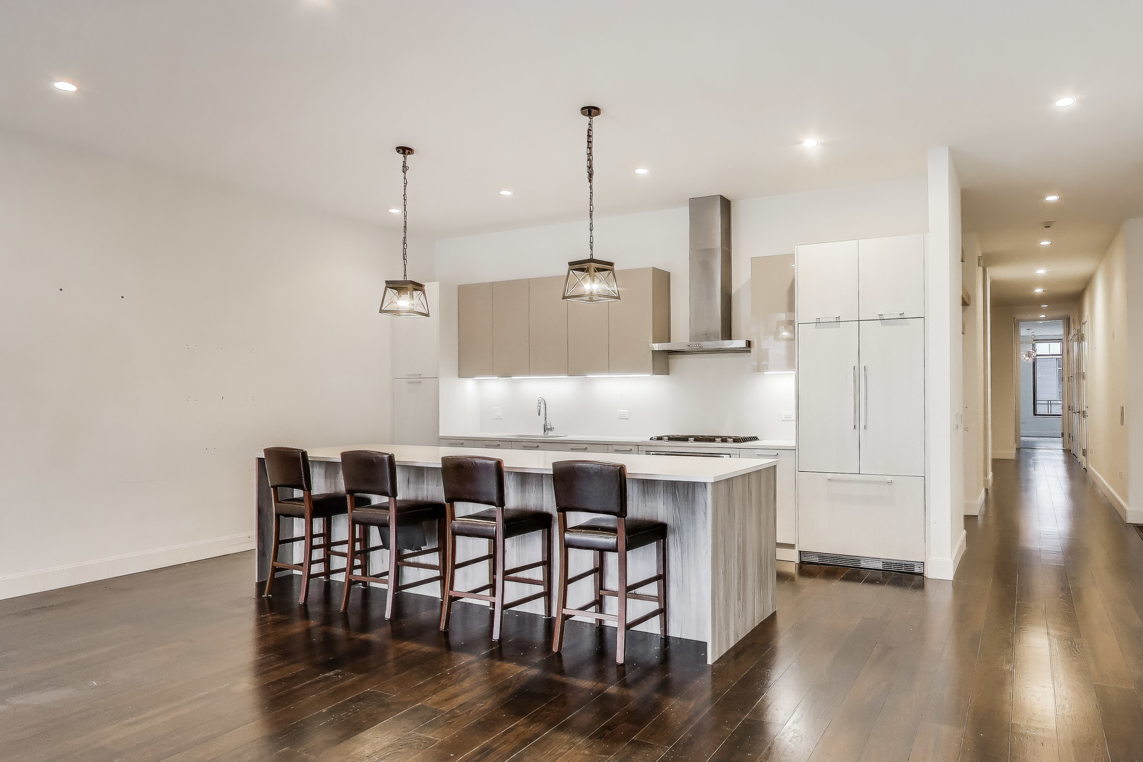 36 North Carpenter Street, Unit 4S Chicago, IL 60607 - Photo 9 of 32 a kitchen with stainless steel appliances granite countertop a stove a sink a refrigerator a dining table and chairs with wooden floor
