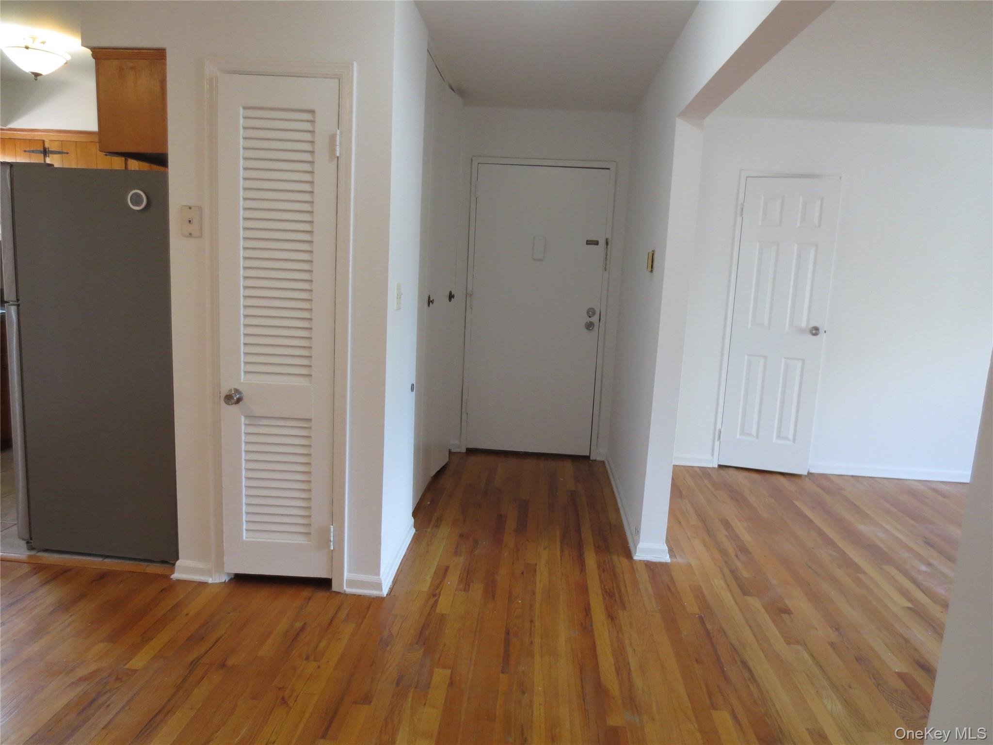 4 Oxford Court, Unit 8007 Suffern, NY 10901 - Photo 2 of 13 Hallway with baseboards and light wood-style flooring