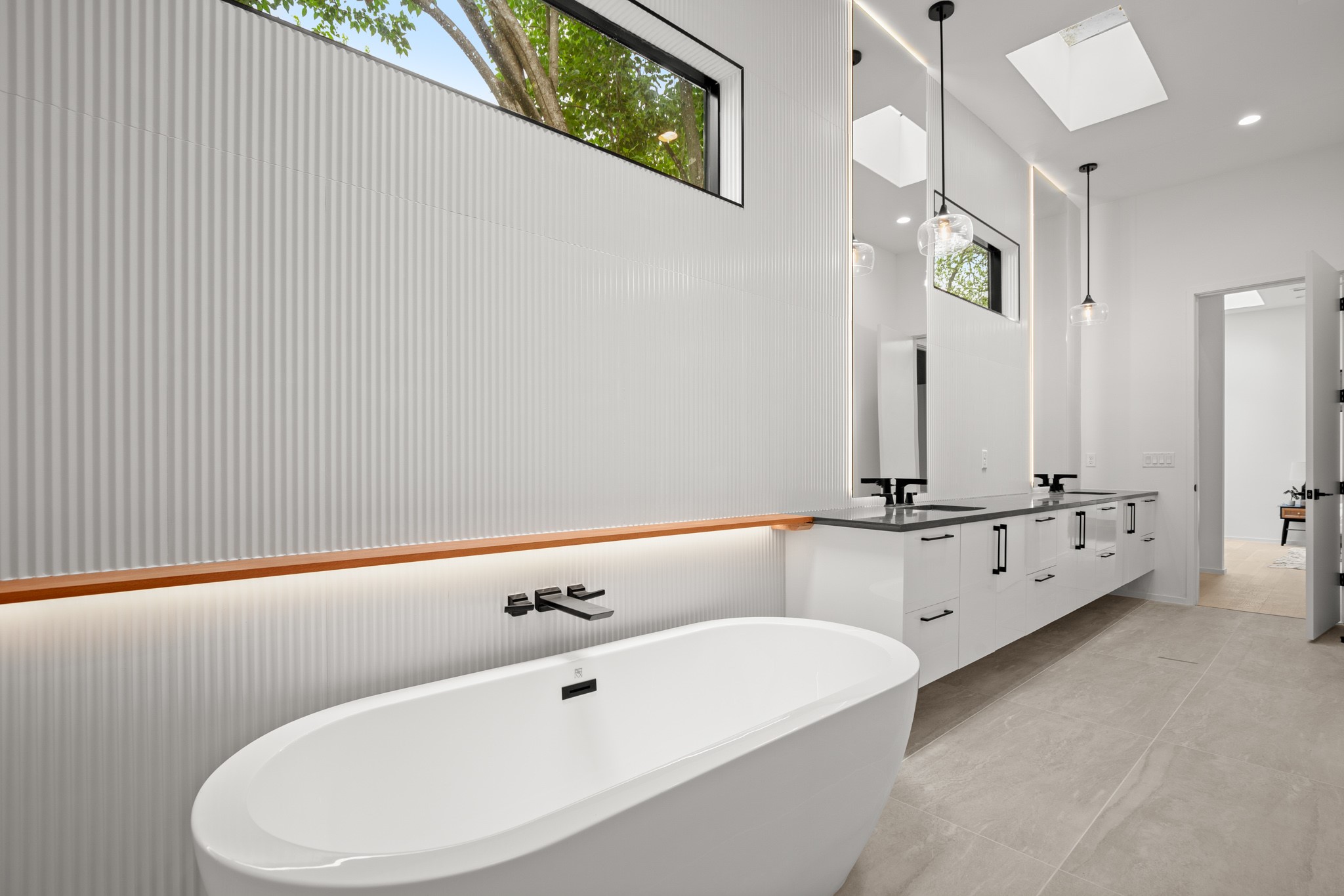 2215 South 3rd Street Austin, TX 78704 - Photo 22 of 38 a bathroom with a bathtub and a double vanity sink