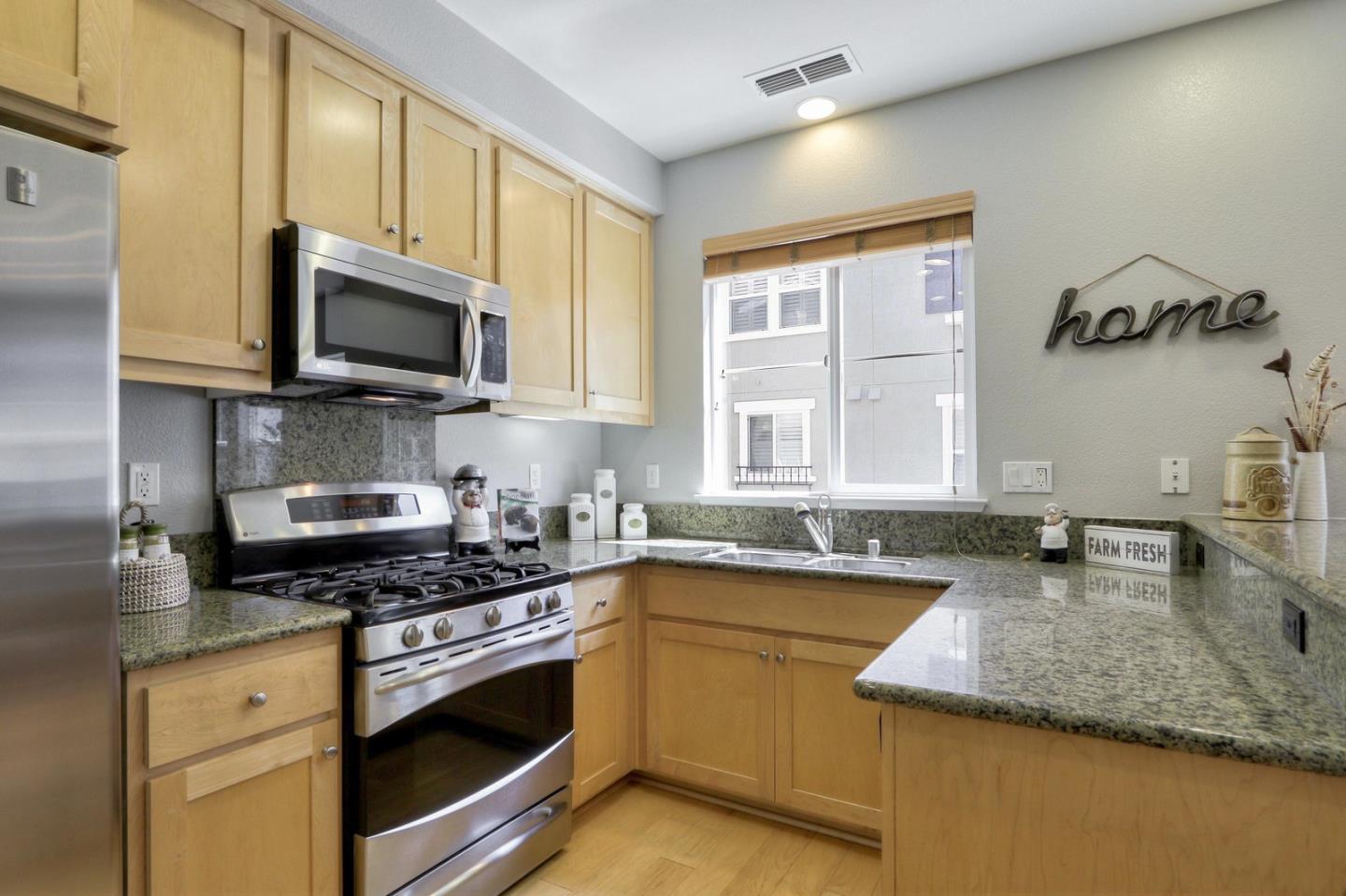 543 Saco Terrace Sunnyvale, CA 94089 - Photo 16 of 50 a kitchen with stainless steel appliances granite countertop a sink a stove top oven a counter space and cabinets