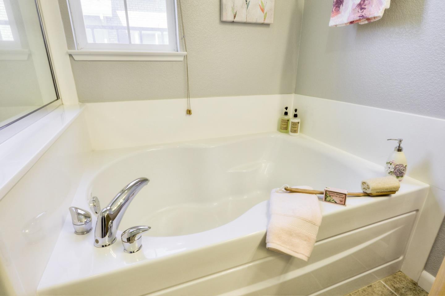 543 Saco Terrace Sunnyvale, CA 94089 - Photo 23 of 50 a bathroom with a bathtub and a window