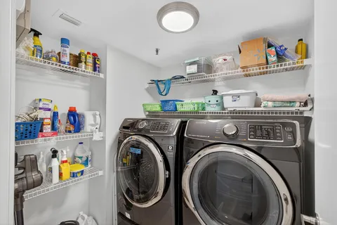 a dining room with furniture and a floor to ceiling window