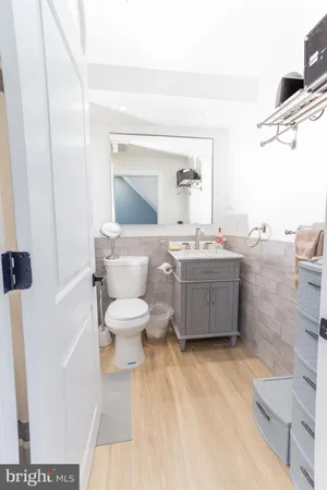 a bathroom with a sink toilet and mirror