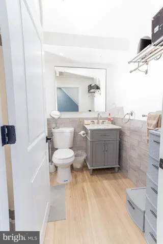 a bathroom with a sink toilet and mirror