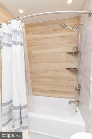 a bathroom with a shower and a tub