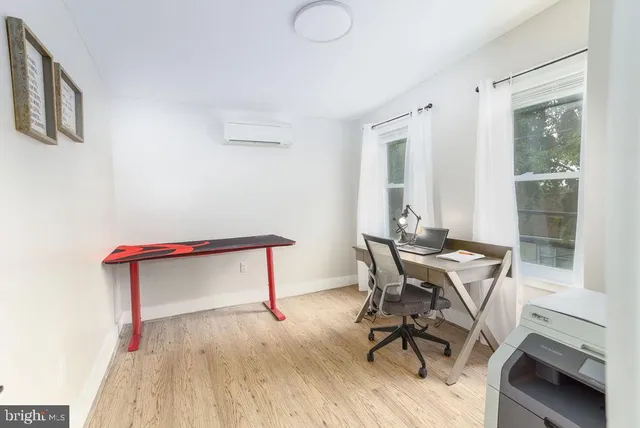a view of a workspace with furniture and a window