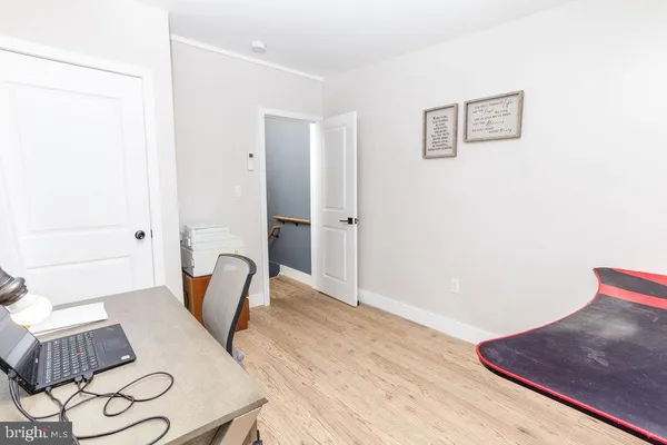 a view of a bedroom with furniture and wooden floor