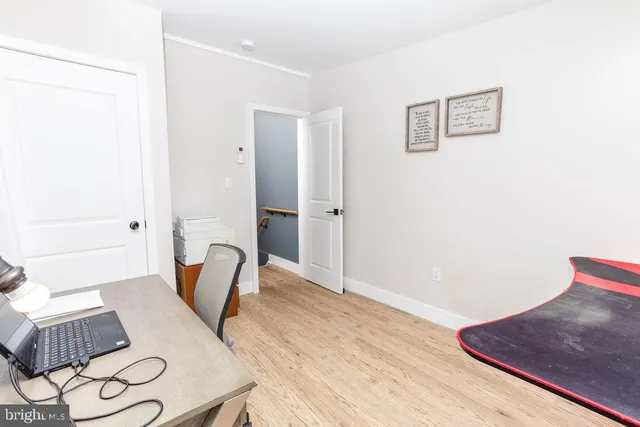 a view of a bedroom with furniture and wooden floor