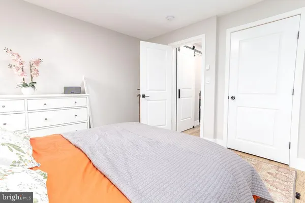 a bedroom with a bed and a dresser in it