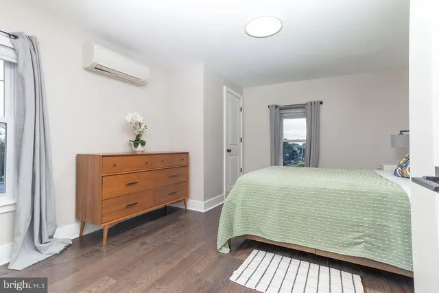 a bedroom with a bed and a dresser