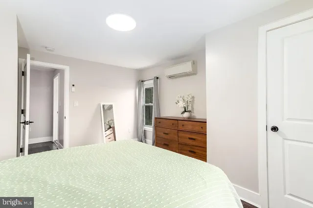 a bedroom with a bed and a dresser